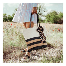 Load the image into the gallery viewer, shopper, large straw bag, beach bag in leo print with zip closure.