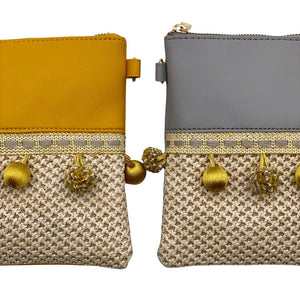 Vegan, organic straw bag, clutch. Shoulder bag in Boho and Ibiza style with pompoms in gray and yellow.